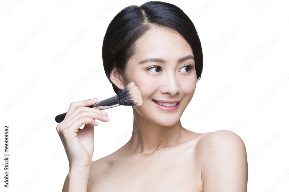 Beautiful young woman with cosmetic brush Beautiful young woman with cosmetic brush