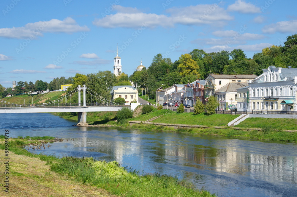 TORZHOK, TVER REGION, RUSSIA - AUGUST 19, 2015: View of the pedestrian bridge, the river Tvertsa embankment