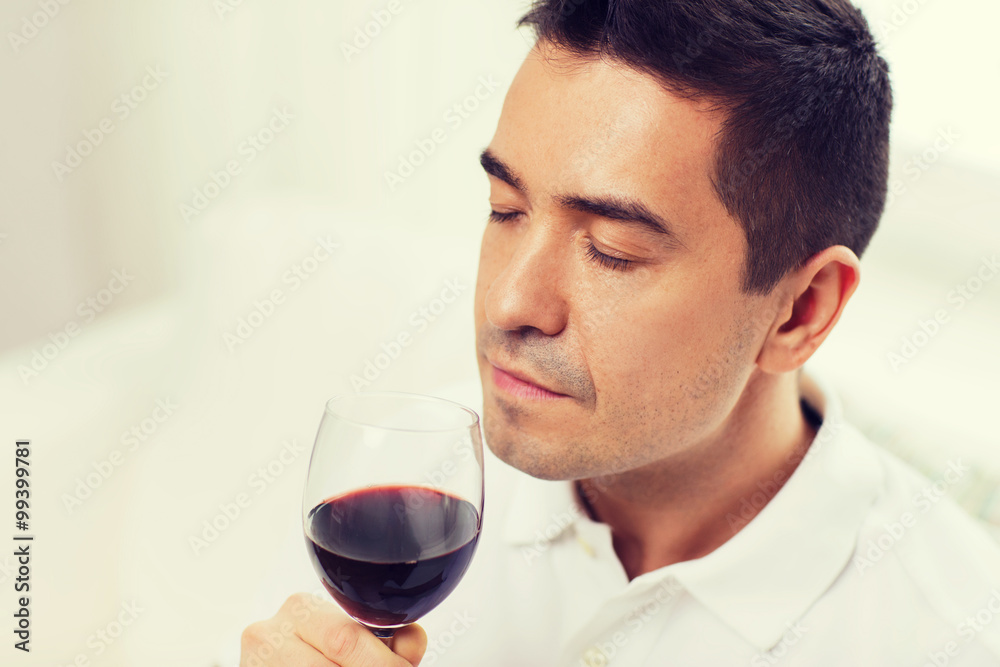 happy man drinking red wine from glass at home happy man drinking red wine from glass at home