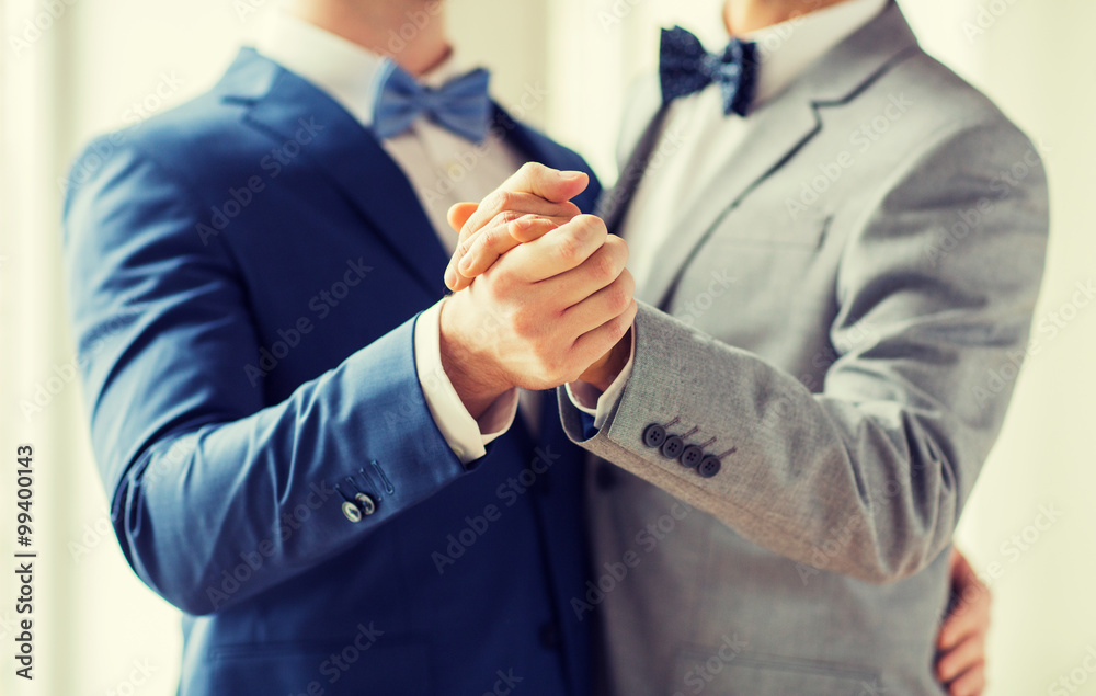 close up of happy male gay couple dancing