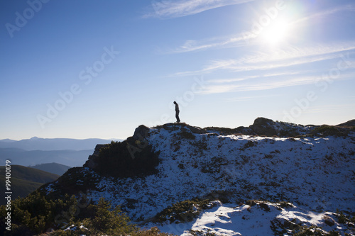 The silhouette of a man in the mountains.