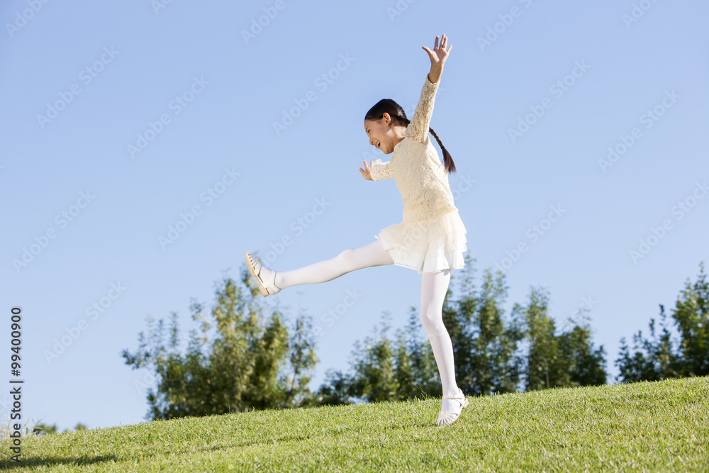 Excited young girl enjoying herself in a park Excited young girl enjoying herself in a park