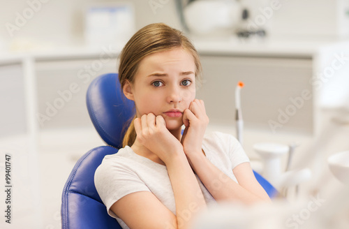 Fototapeta Naklejka Na Ścianę i Meble -  scared and terrified patient girl at dental clinic