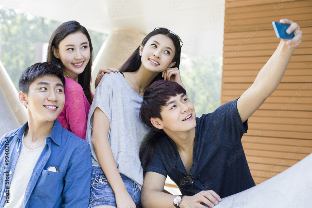 Young friends taking self portrait with a smart phone Young friends taking self portrait with a smart phone