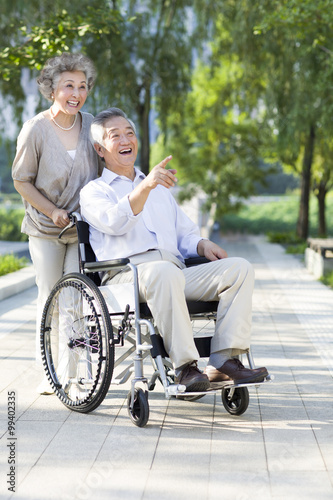 Senior woman with wheelchair bound husband