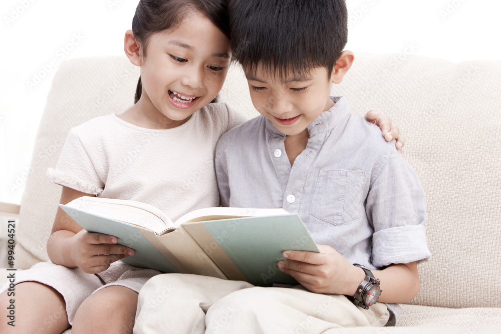 Little boy and girl reading a book Little boy and girl reading a book