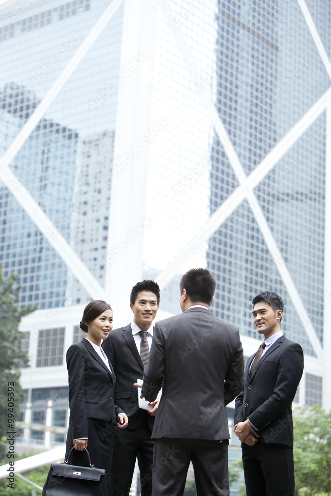 Cheerful business persons discussing with each other in Hong Kong Cheerful business persons discussing with each other in Hong Kong