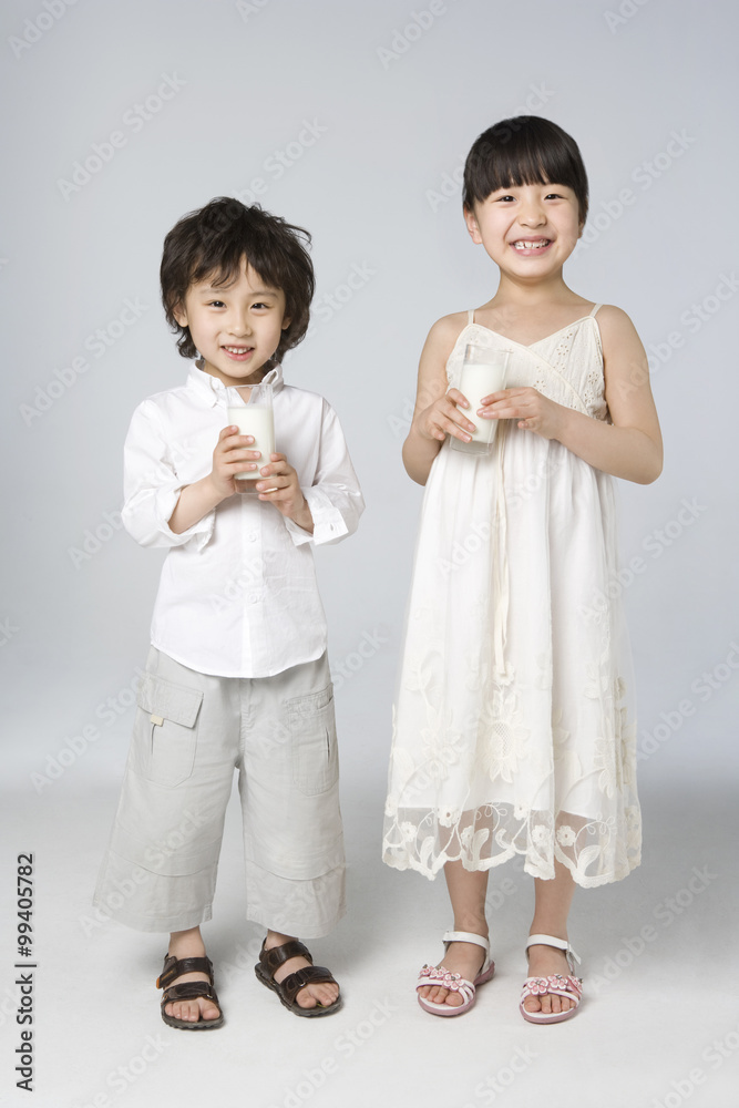 Children each holding a glass of milk