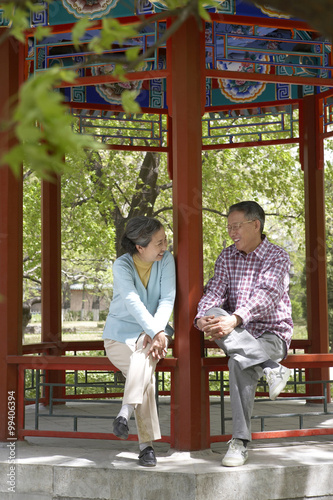 Senior Couple Relaxing In Park Together