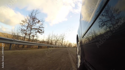 Car driving a countryside road on a sunny day