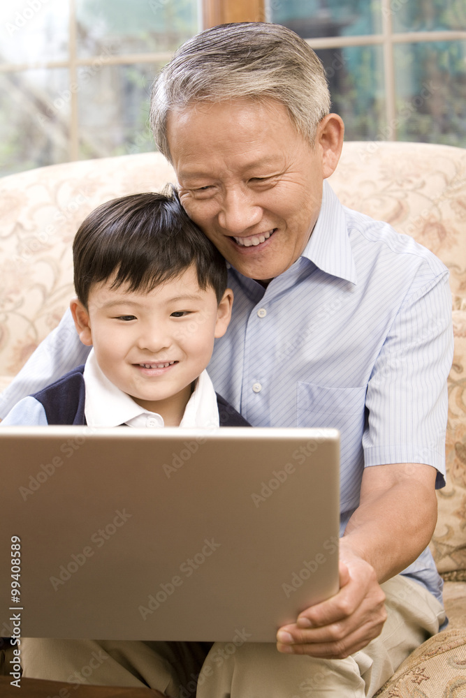 Grandfather and grandson using laptop Grandfather and grandson using laptop