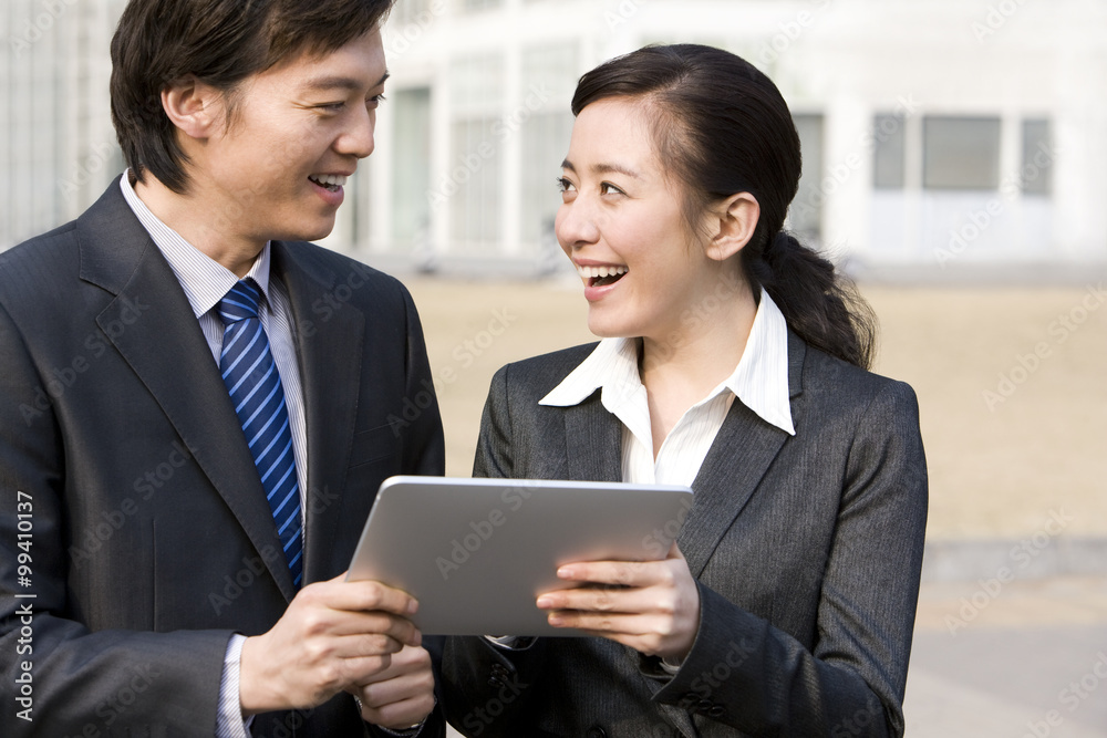 Business partners having fun with a digital tablet Business partners having fun with a digital tablet