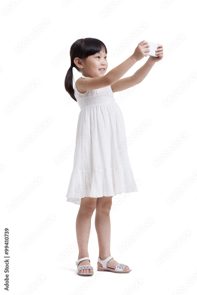 Cute little girl taking pictures with smart phone Cute little girl taking pictures with smart phone