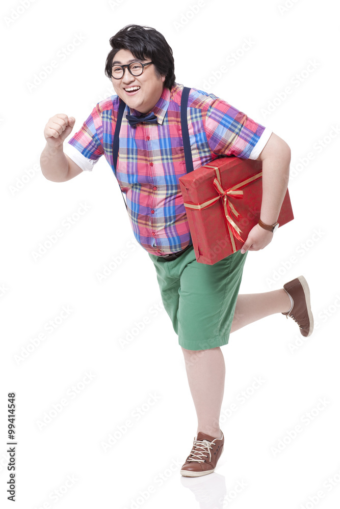 Fototapeta premium Cheerful Chubby man running with gift in hand