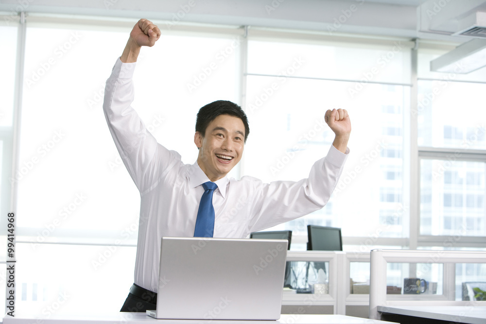Happy office worker at his desk