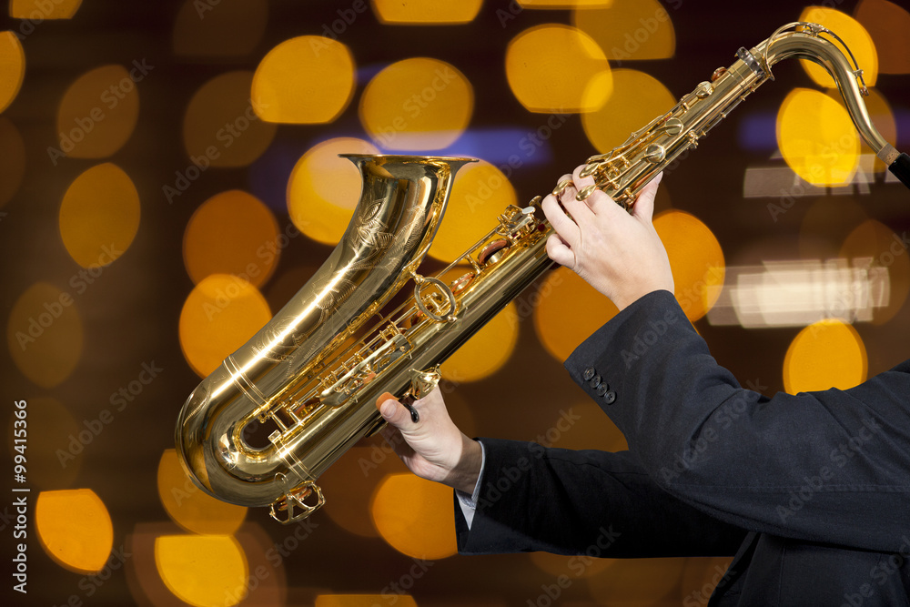 Fototapeta premium Saxophonist. Man playing on saxophone