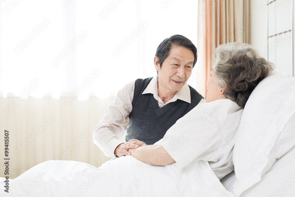 Senior man taking care of wife in hospital Senior man taking care of wife in hospital