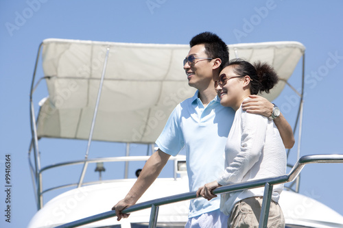 Couple Enjoying the View from the Yacht Deck © Blue Jean Images