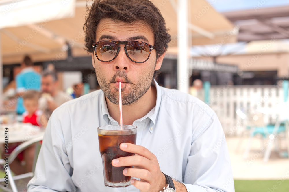 Young man drinking a beverage Young man drinking a beverage