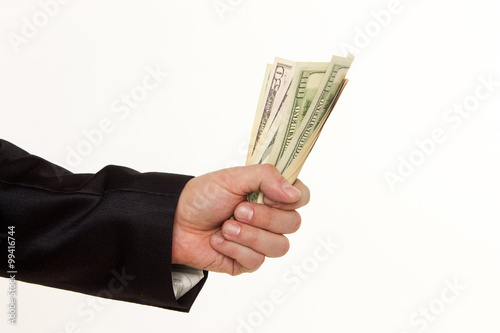 Man's hand holding a handful of dollars.