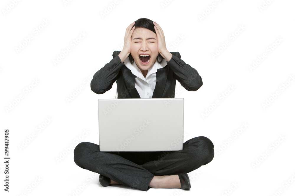 A businesswoman holding a laptop computer A businesswoman holding a laptop computer