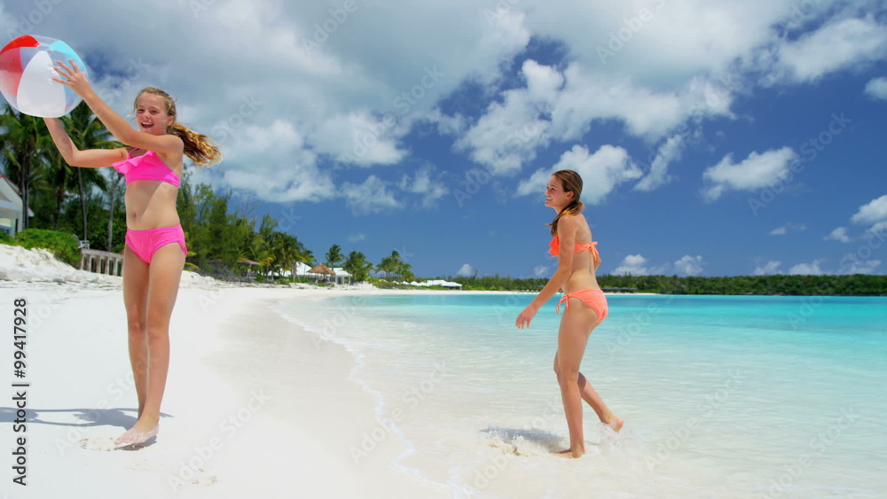 Pretty female Caucasian children in swimwear enjoying a tropical vacation Pretty female Caucasian children in swimwear enjoying a tropical vacation