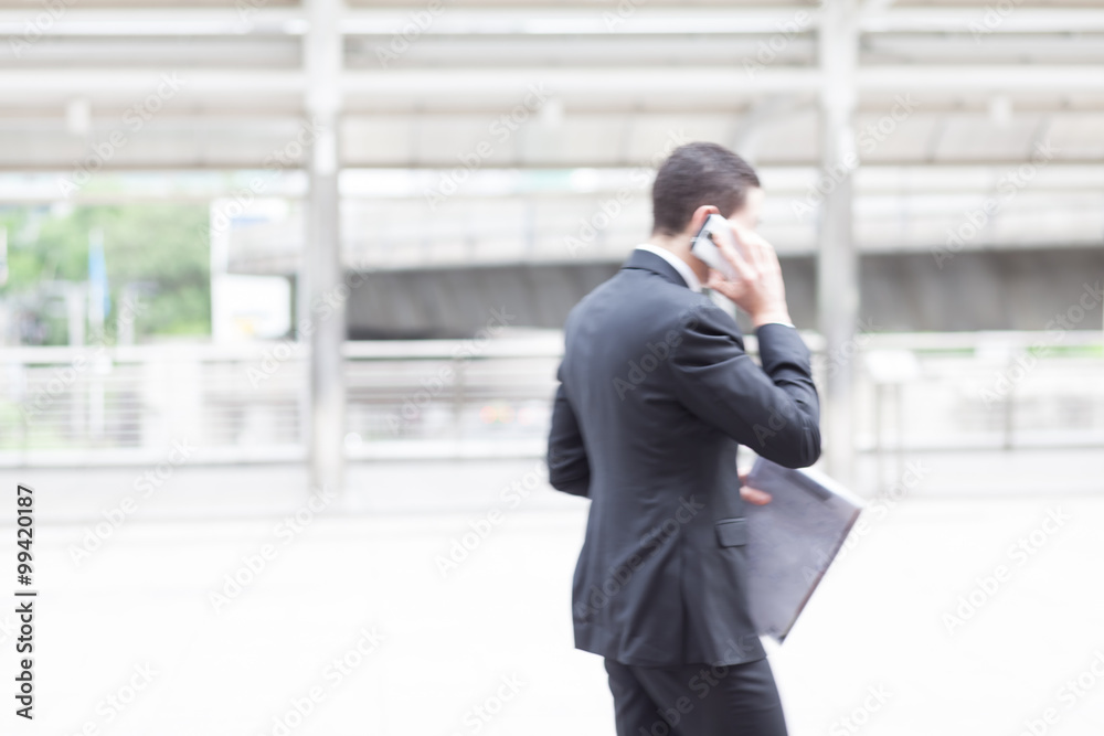 motion blur businessman talking on mobile phone motion blur businessman talking on mobile phone