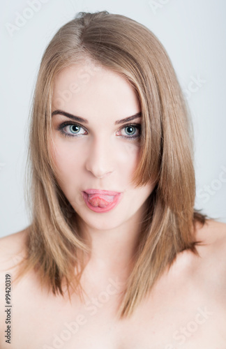 Beautiful woman model sticking tongue out as funny face concept