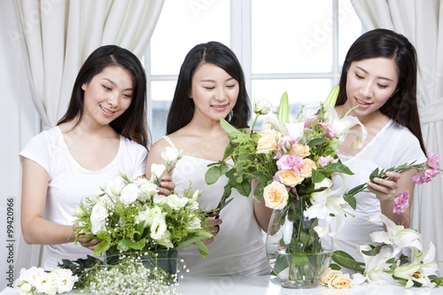 Best female friends arranging flowers together