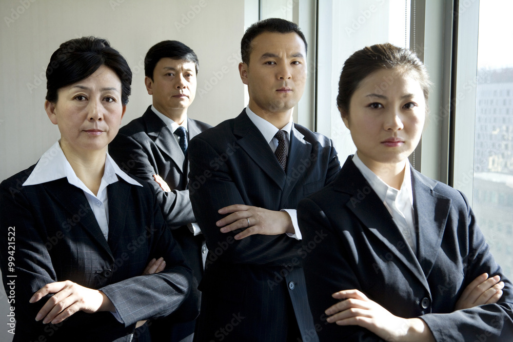 Four business professionals in front of window Four business professionals in front of window