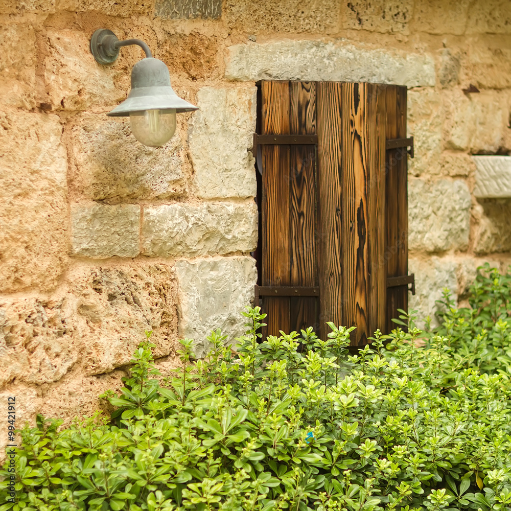 Lamp and wooden window shutters