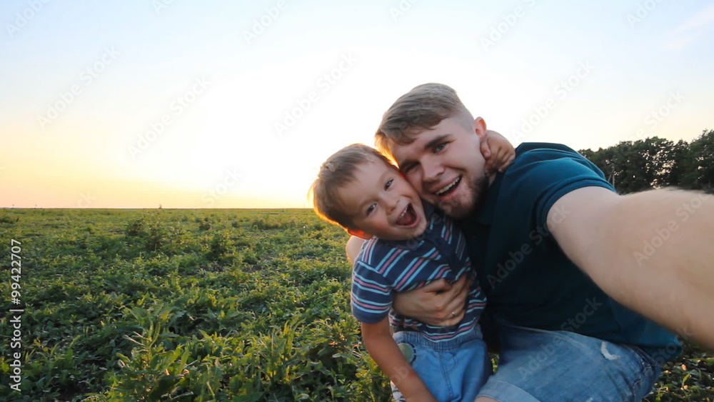 Happy smiling father and son take a self picture slowmotion Happy smiling father and son take a self picture slowmotion