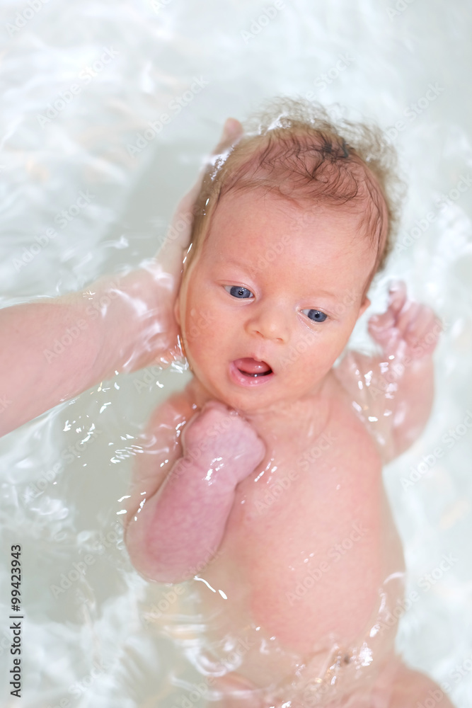 Newborn baby swimming in bath Newborn baby swimming in bath