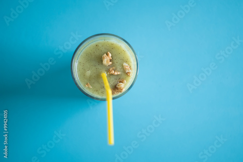 Chocolate banana smoothie in a glass with straws