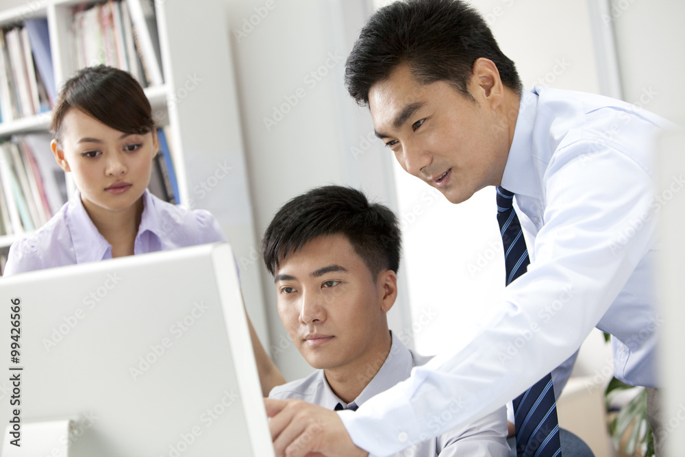 Businessmen working in front of a computer