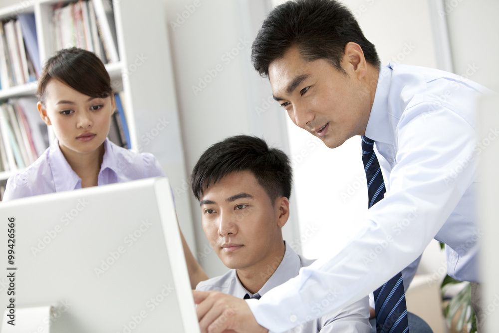 Businessmen working in front of a computer Businessmen working in front of a computer