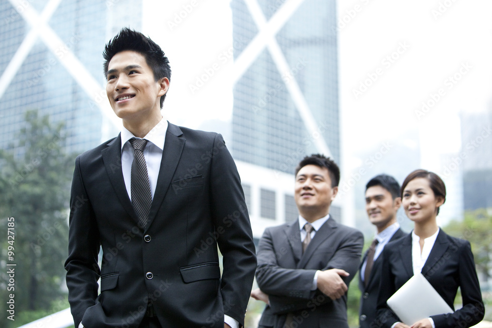 Cheerful businessman with his team in Hong Kong Cheerful businessman with his team in Hong Kong