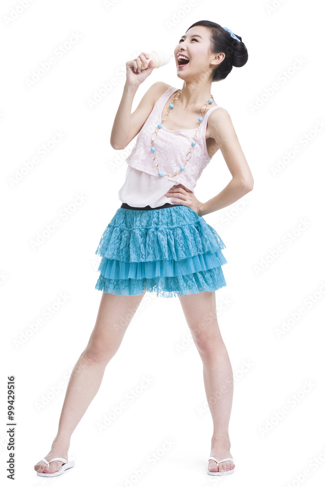 Excited young woman with ice cream cone singing Excited young woman with ice cream cone singing