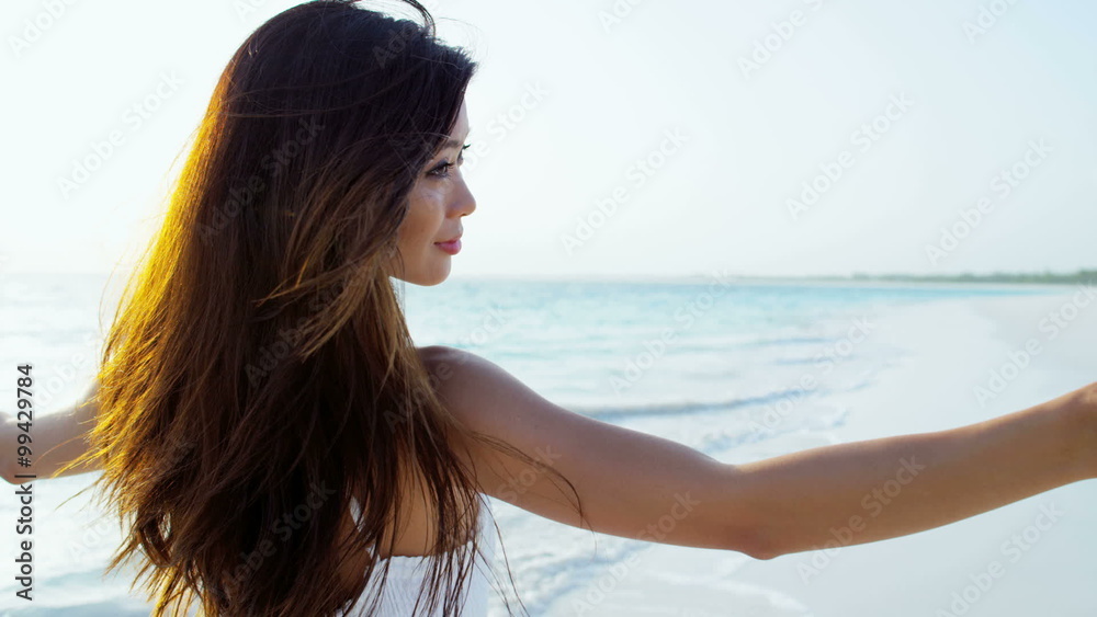 Asian American girl enjoying vacation beach by tropical ocean Asian American girl enjoying vacation beach by tropical ocean