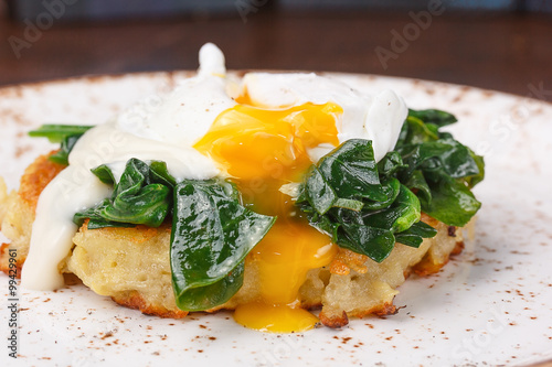 The poached egg on the cutlet from potatoes with spinach.