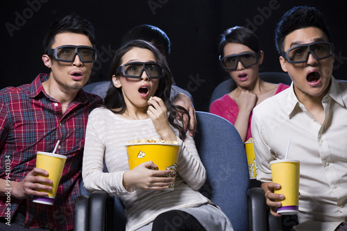 Young couple watching 3D movie in cinema