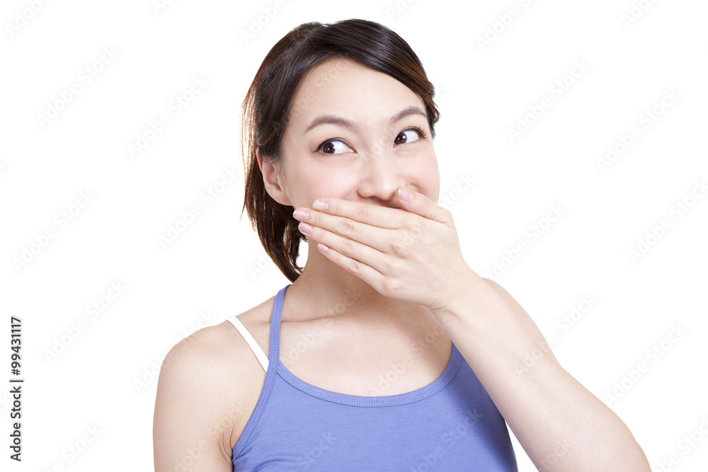 Cute young woman smiling with hands covering mouth Cute young woman smiling with hands covering mouth