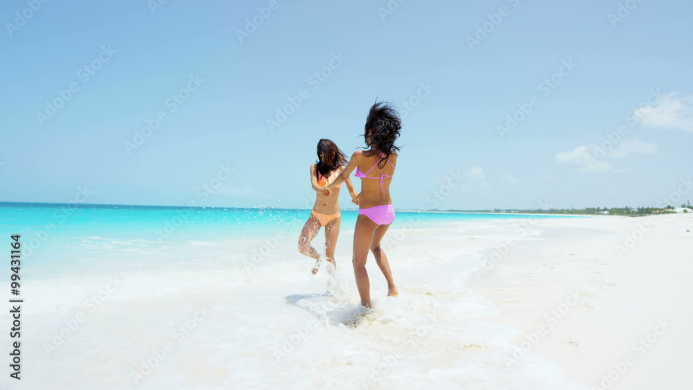 Laughing multi ethnic girls enjoying tropical beach Laughing multi ethnic girls enjoying tropical beach