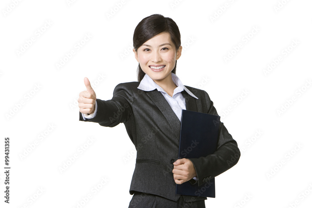 Cheerful young businesswoman showing thumbs up sign Cheerful young businesswoman showing thumbs up sign