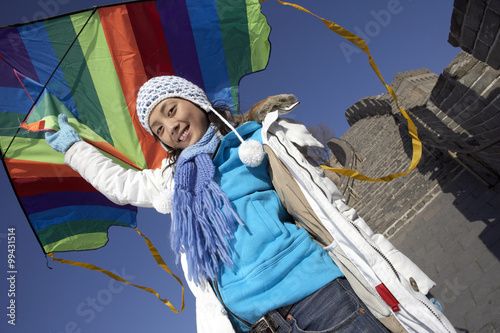 Young Woman On The Great Wall Of China Flying A Kite