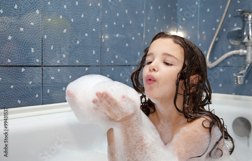 little girl playing with soap bubbles