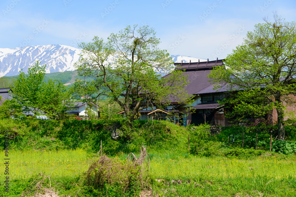 Shirouma mountains and old houses at Ooide park in Hakuba, Nagano, Japan Shirouma mountains and old houses at Ooide park in Hakuba, Nagano, Japan
