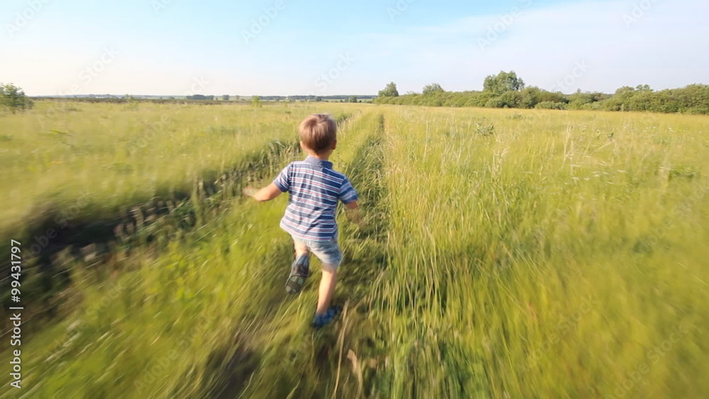 Boy running across hill in slowmotion Boy running across hill in slowmotion