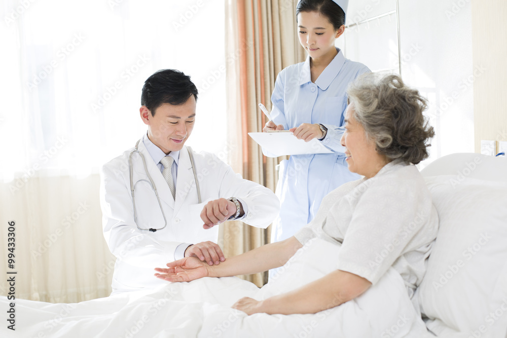 Doctor taking pulse of patient in hospital Doctor taking pulse of patient in hospital