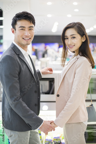 Young couple shopping in electronics store